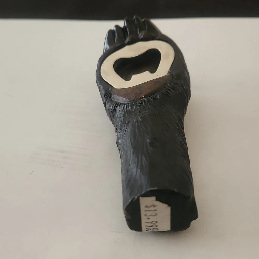 RESIN AND METAL BEAR PAW BOTTLE OPENER.
